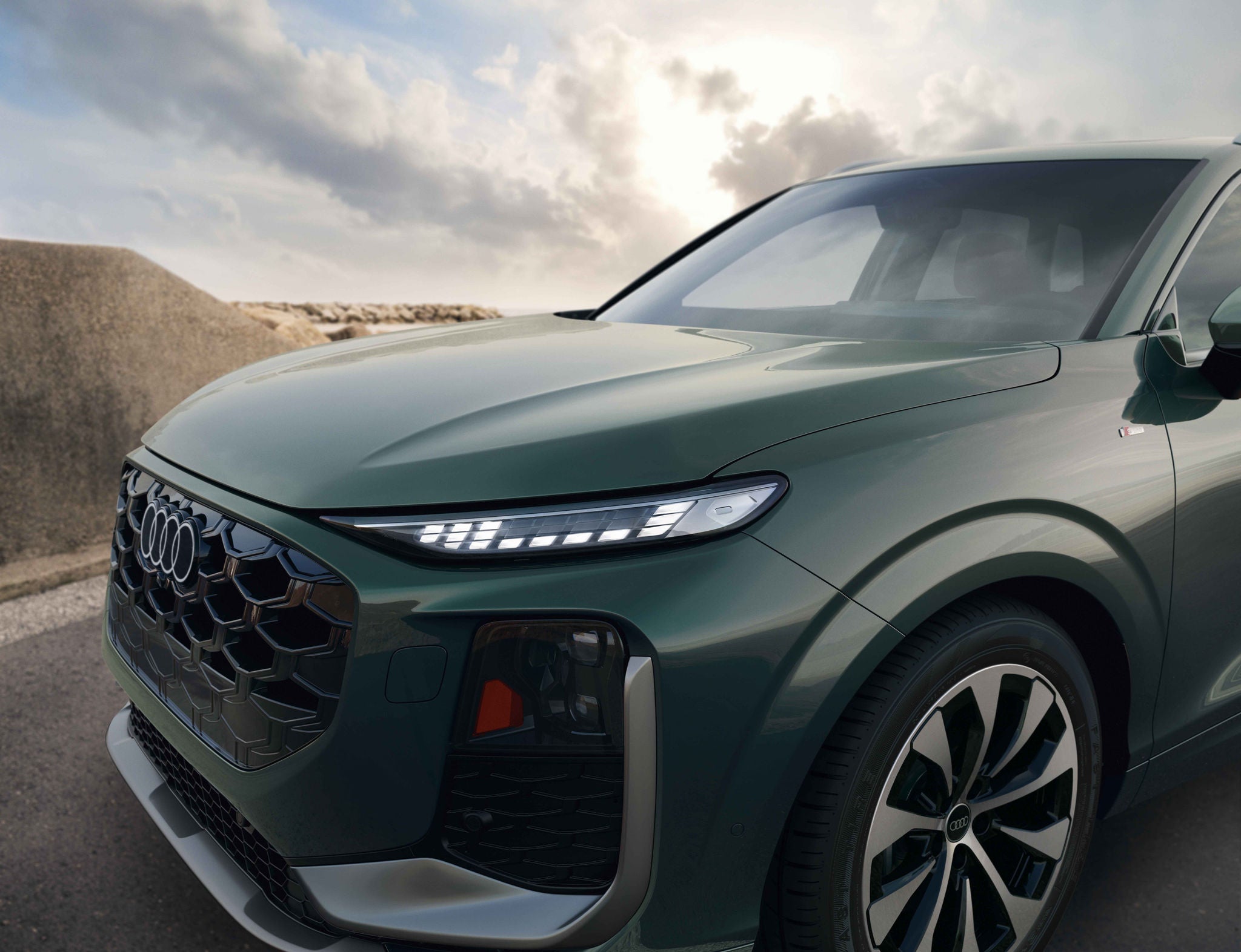 Right profile view of an Audi Q3 parked.